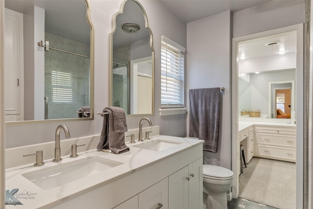 bathroom with walk in shower, tile patterned floors, vanity, and toilet