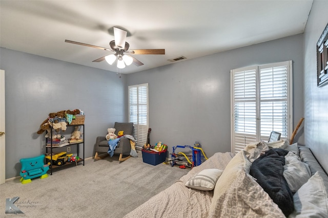 bedroom featuring multiple windows, carpet floors, and ceiling fan