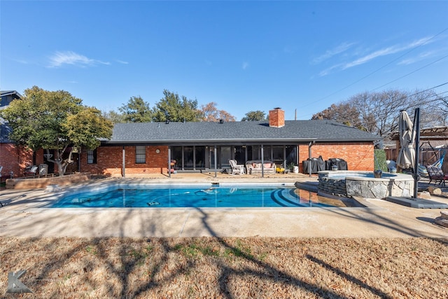 view of swimming pool featuring an in ground hot tub and a patio