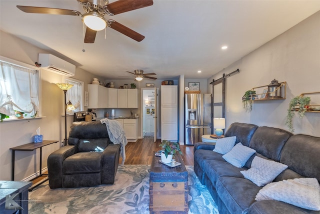 living room with a wall mounted air conditioner, a barn door, and dark hardwood / wood-style floors