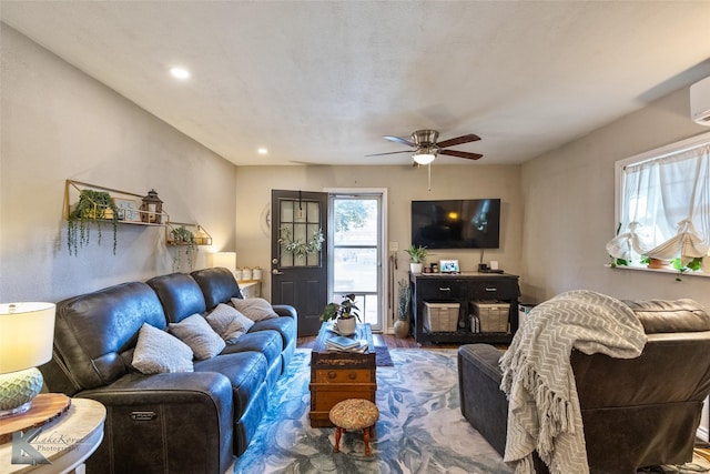 living room with hardwood / wood-style flooring and ceiling fan