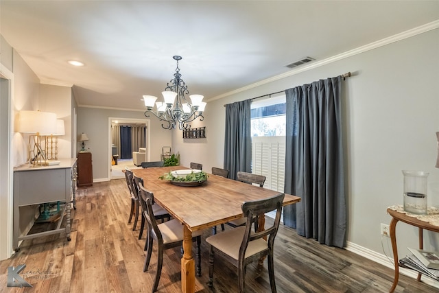 dining room featuring ornamental molding, an inviting chandelier, and wood-type flooring