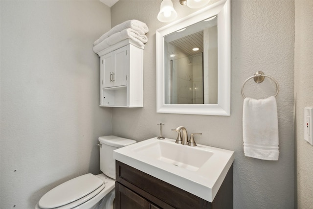 bathroom with vanity, toilet, and walk in shower