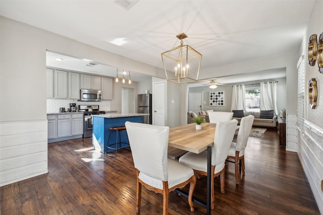 dining room with an inviting chandelier and dark hardwood / wood-style floors