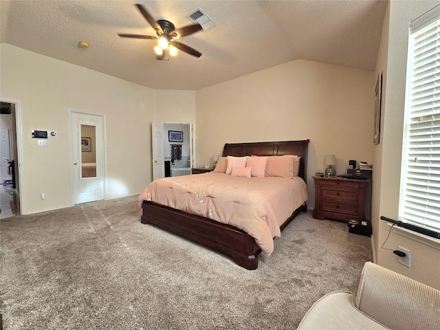 bedroom featuring a textured ceiling, ceiling fan, carpet floors, and vaulted ceiling