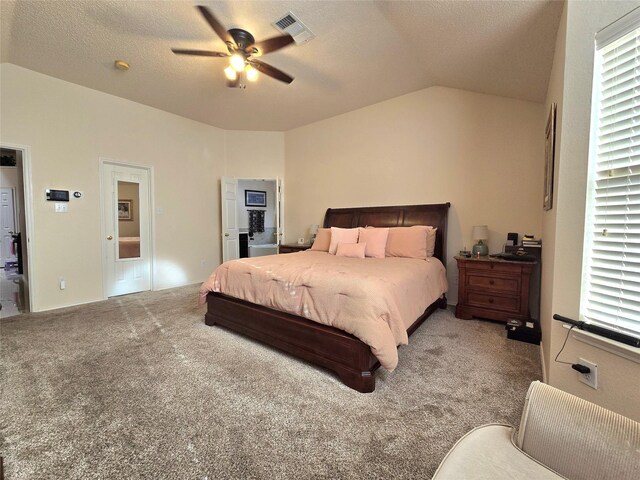 bedroom with lofted ceiling, ceiling fan, a textured ceiling, and carpet flooring