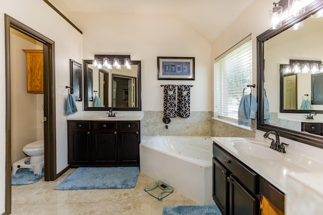 bathroom with a washtub, vanity, toilet, and lofted ceiling