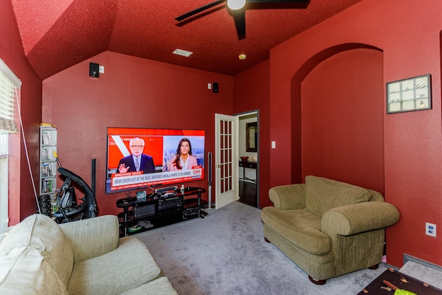 carpeted cinema room featuring ceiling fan and lofted ceiling