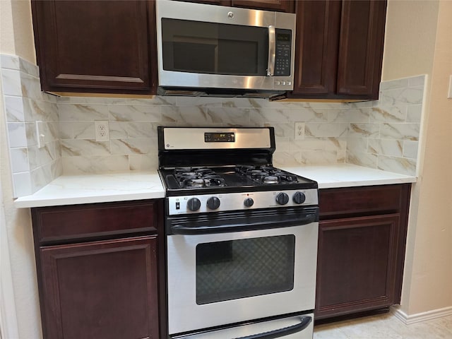 kitchen with tasteful backsplash and gas range