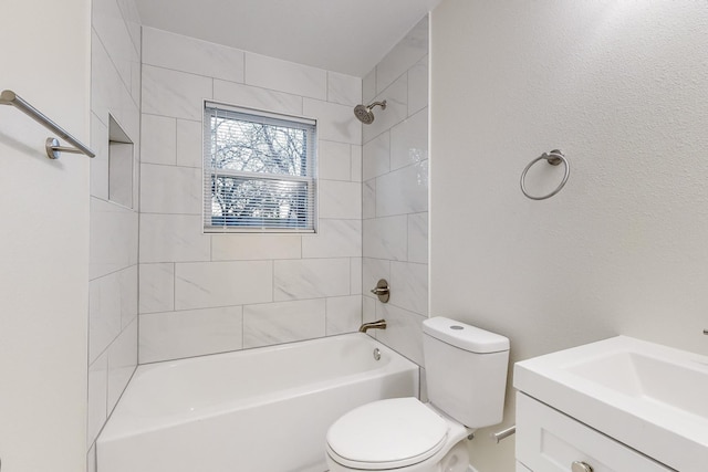 full bathroom with vanity, tiled shower / bath combo, and toilet