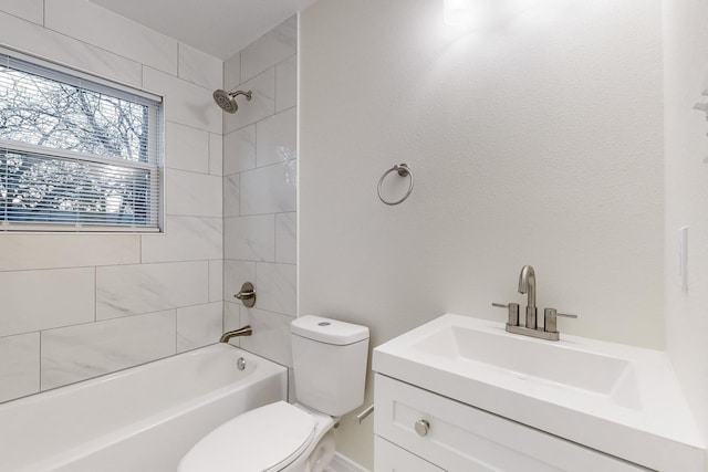 full bathroom featuring vanity, toilet, and tiled shower / bath