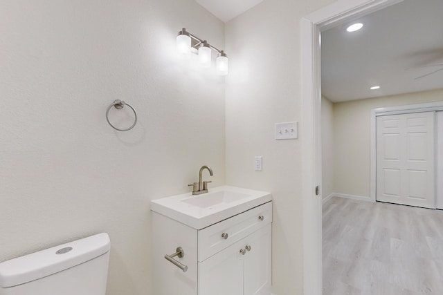 bathroom featuring hardwood / wood-style floors, vanity, and toilet