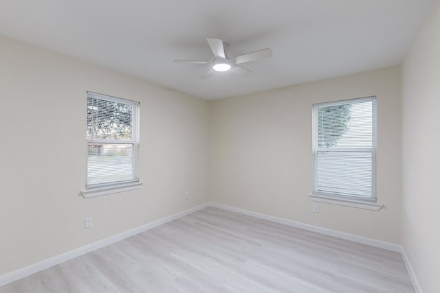 unfurnished room featuring ceiling fan, light hardwood / wood-style floors, and a wealth of natural light