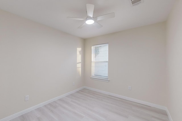 spare room featuring light hardwood / wood-style floors and ceiling fan