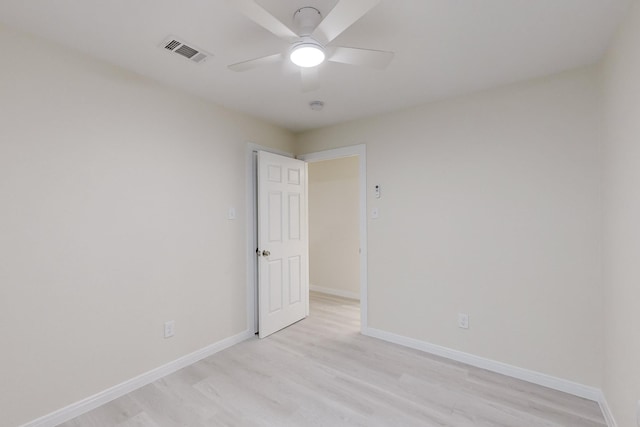 spare room featuring ceiling fan and light hardwood / wood-style floors