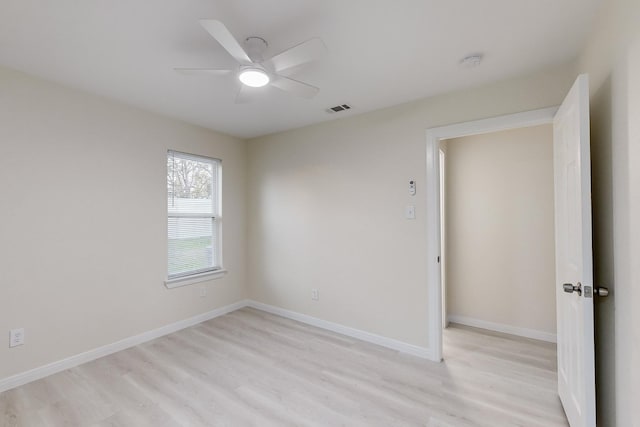 spare room featuring ceiling fan and light hardwood / wood-style flooring