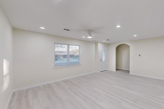 empty room featuring ceiling fan and light wood-type flooring