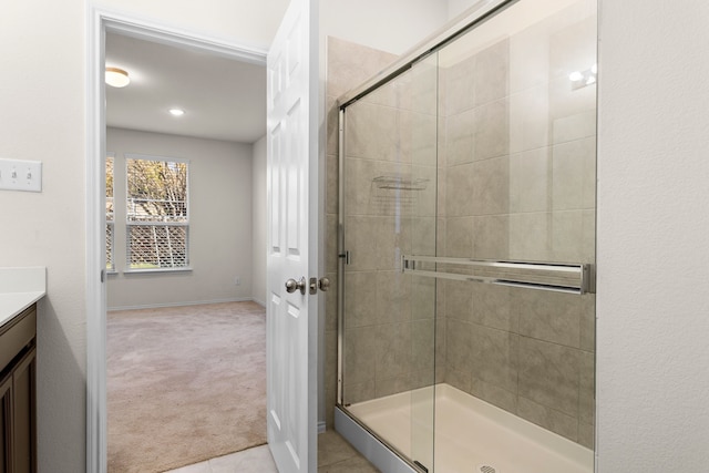 bathroom featuring tile patterned floors, vanity, and an enclosed shower