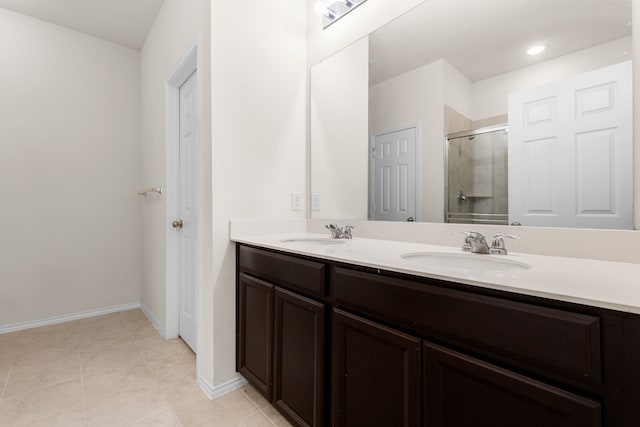 bathroom featuring tile patterned floors, vanity, and an enclosed shower