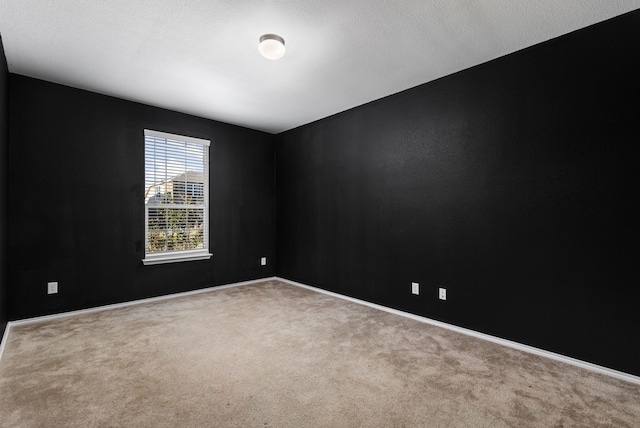 carpeted spare room featuring a textured ceiling