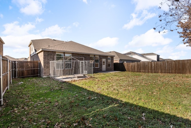 rear view of house featuring a lawn