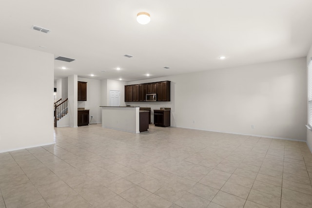 unfurnished living room with light tile patterned floors