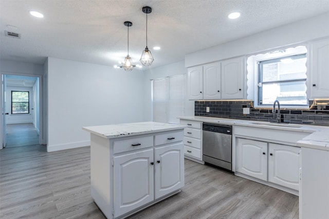 kitchen with white cabinets, dishwasher, pendant lighting, and a kitchen island