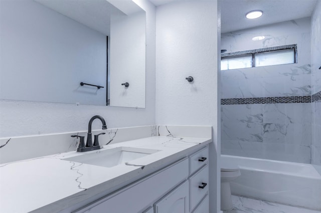 full bathroom featuring vanity, tiled shower / bath combo, and toilet