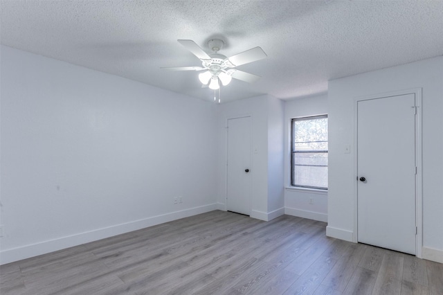 unfurnished bedroom with ceiling fan, light hardwood / wood-style floors, and a textured ceiling