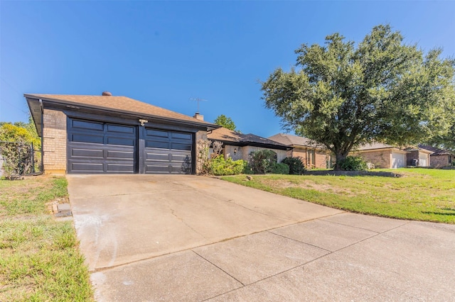 view of front of home with a garage and a front lawn