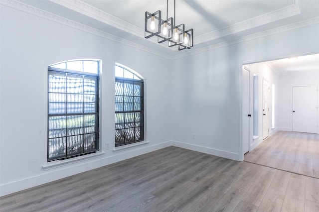 unfurnished dining area with a chandelier, hardwood / wood-style flooring, and crown molding