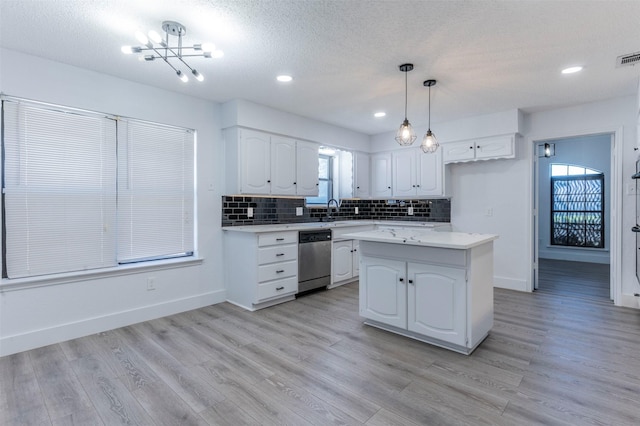 kitchen with dishwasher, decorative light fixtures, a center island, and white cabinets