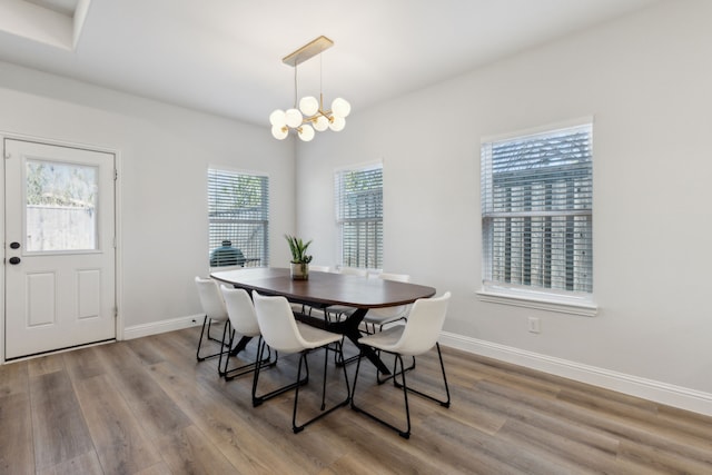 dining room with a chandelier and light hardwood / wood-style flooring