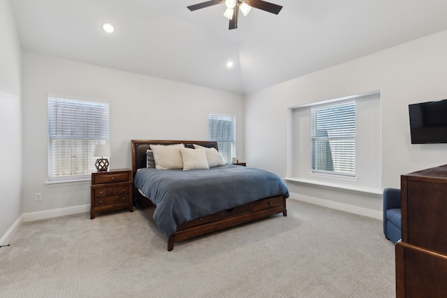 bedroom featuring lofted ceiling, light carpet, and baseboards