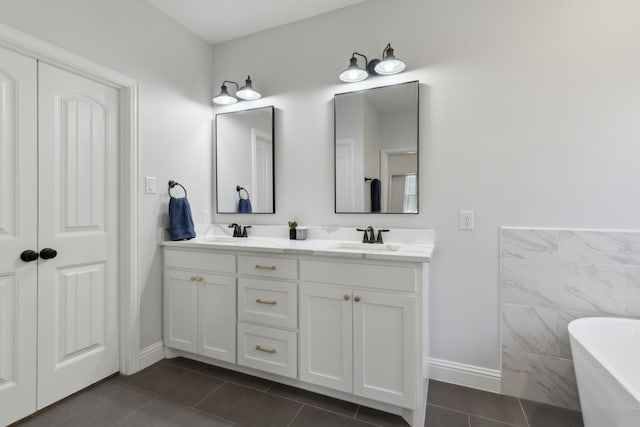 bathroom featuring vanity, a bath, and tile patterned floors