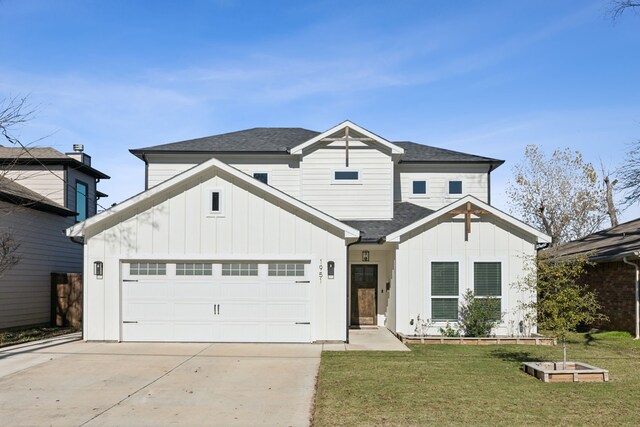 modern farmhouse featuring a front yard and a garage