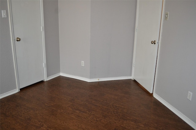 unfurnished room featuring dark hardwood / wood-style floors