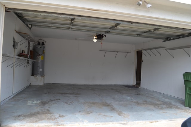 garage with electric water heater and a garage door opener