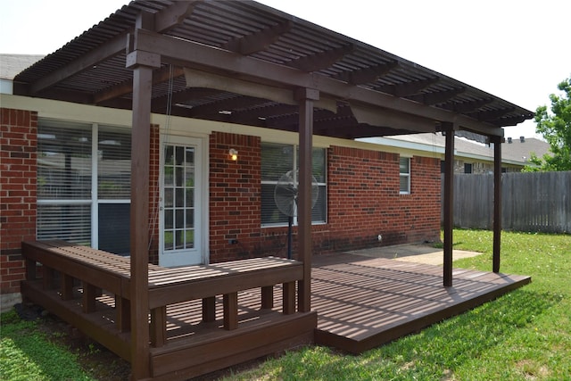 wooden deck with a pergola, a patio area, and a lawn