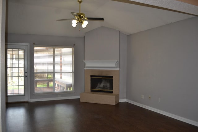 unfurnished living room with ceiling fan, vaulted ceiling, dark hardwood / wood-style floors, and a brick fireplace