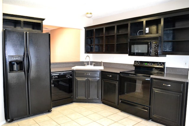 kitchen featuring light tile patterned floors, sink, and black appliances