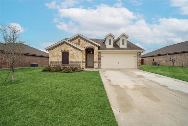 view of front of house with central AC, a garage, and a front yard