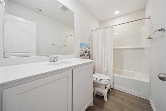 full bathroom featuring vanity, toilet, wood-type flooring, and shower / tub combo