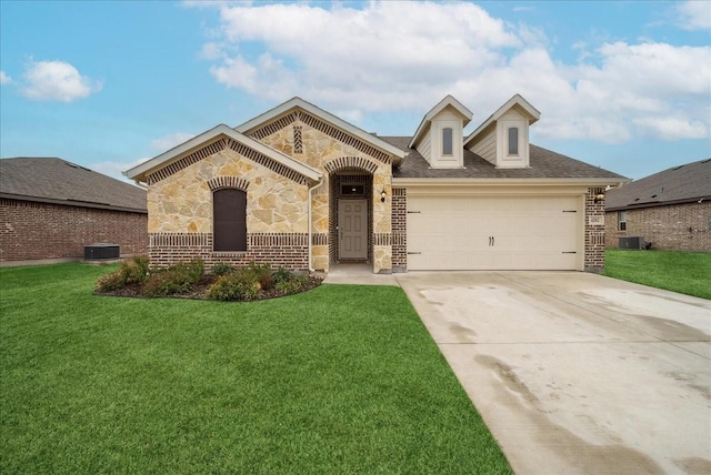 view of front of home with cooling unit, a front yard, and a garage