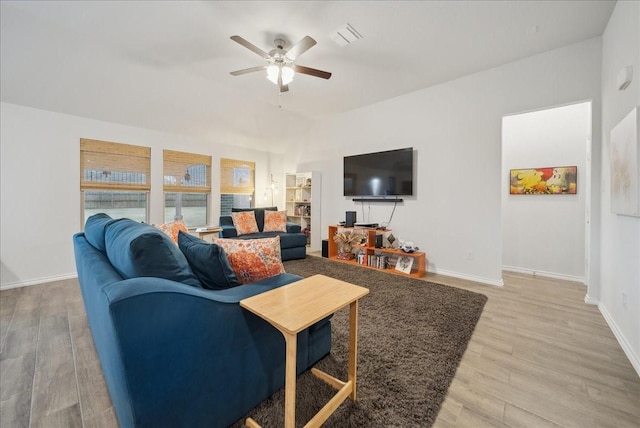 living room with wood-type flooring and ceiling fan