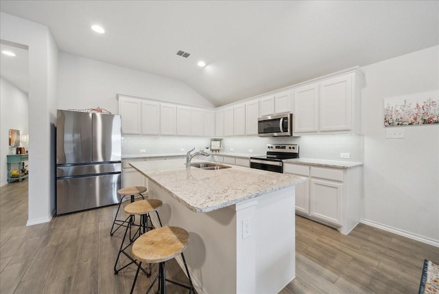 kitchen with white cabinets, sink, an island with sink, and appliances with stainless steel finishes