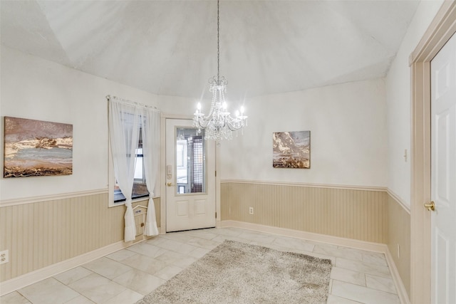 doorway featuring tile patterned flooring and a chandelier