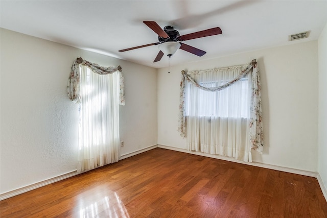 spare room with ceiling fan and hardwood / wood-style flooring