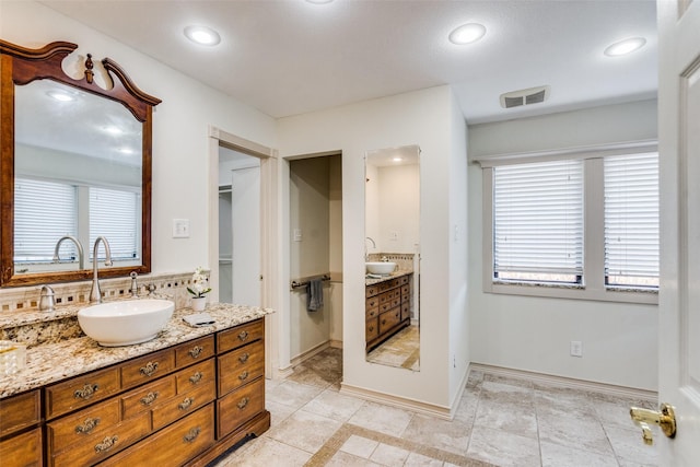 bathroom featuring tile patterned floors, vanity, and a healthy amount of sunlight