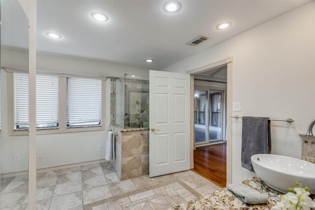 bathroom with a tile shower